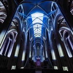 Právě proto, že podkladovou plochou se tu stávají do nebes se vzpínající zdi neogotické katedrály. Kamenný podklad není odrazem pro digitální pomítačky, ale spíš úctyhodným plátnem pro sekvence obživlých obrazů. Foto: AURA Grace Cathedral, Moment Factory.