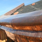 Zaoblené rohy okenního ostění i kulaté rohy tvoří jednotný ráz domu. Strop je z modřínového dřeva a kopíruje sklon střechy 